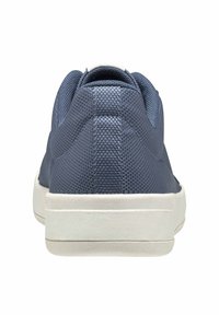 Modré tenisky s texturovaným svrškem, bílou gumovou podrážkou a nízkým profilem. Mají zaoblenou špičku a polstrovaný límec.