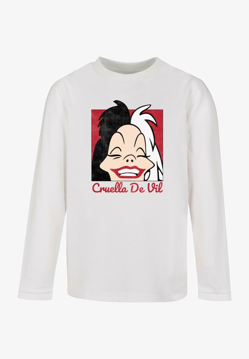 Pikkade varrukatega valge särk, millel on kujundus Cruella de Vili musta ja valge juustega, naeratamas punase ruudukujulise tausta ees.