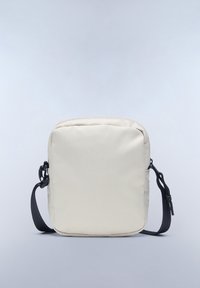Beige fabric crossbody bag with a zip closure, featuring a black adjustable strap and a smooth texture. Square design with rounded edges.