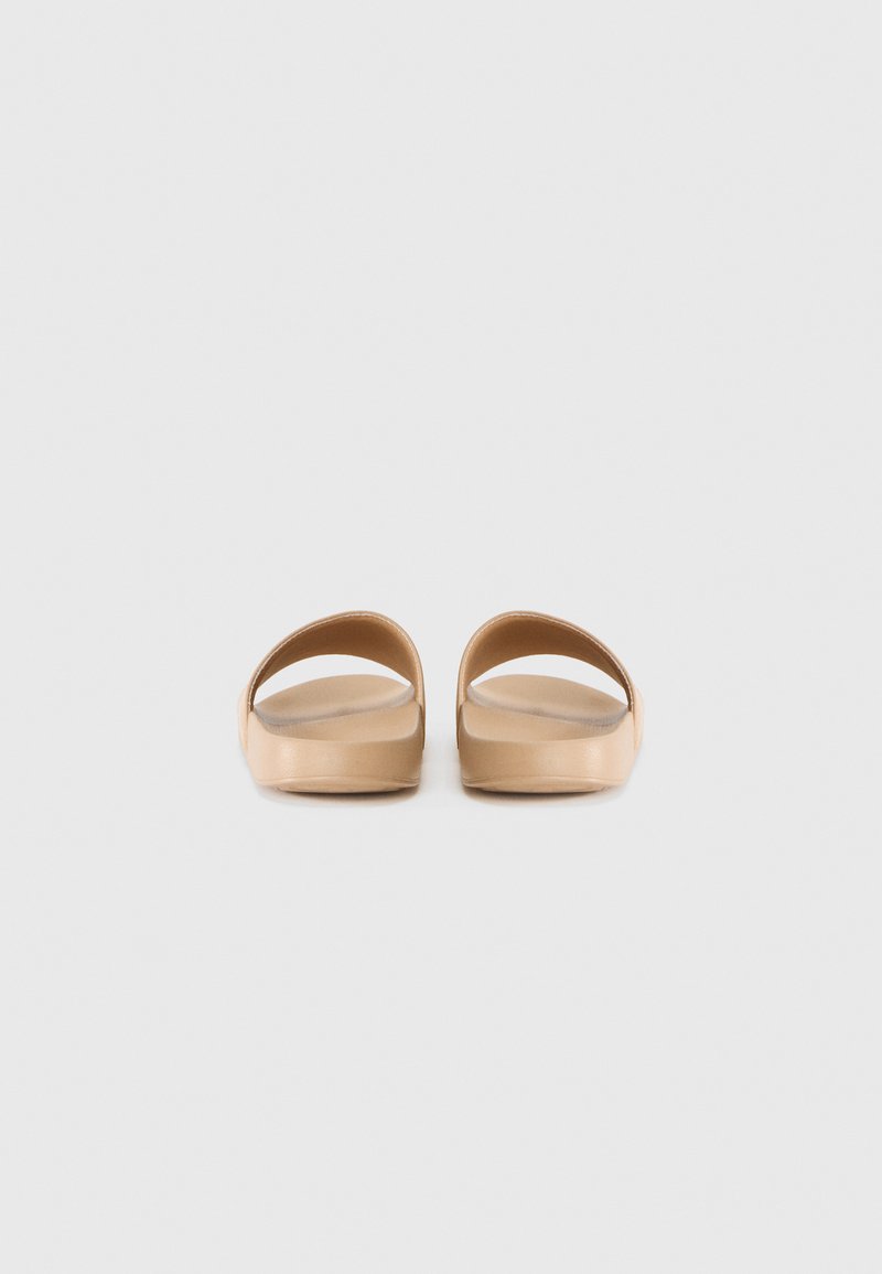 Chanclas tan con un diseño abierto, que presentan correas redondeadas y un acabado suave, fabricadas con material similar al caucho.