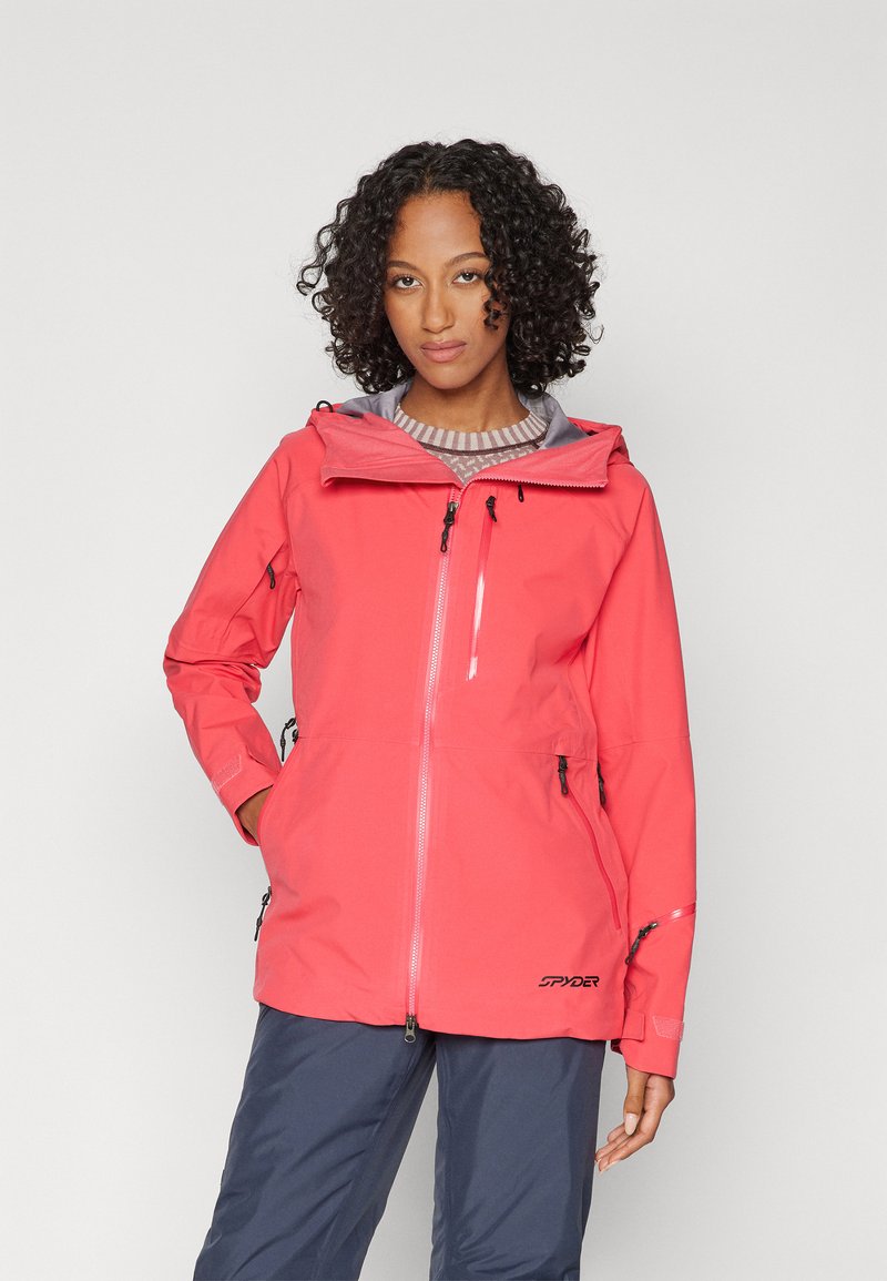 Koralle wasserfeste Jacke mit Frontreißverschluss, verstellbarem Kapuzen und mehreren Reißverschlusstaschen. Mit grauem Innenfutter und Logo am Saum.