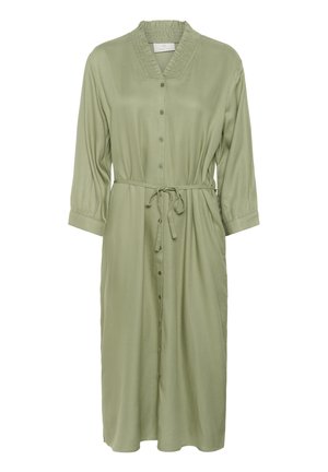 Majica haljina s dugim rukavima u svijetlozelenoj tkanini, s ušivenim ovratnikom, spremljenim strukom i dužinom do koljena. Glatka, lepršava tekstura.