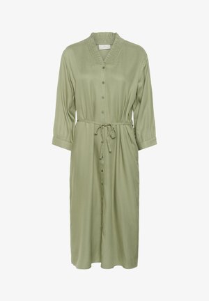 Srajčna obleka z gumbki iz svetlo zelene tkanine, z nabranim ovratnikom, dolgimi rokavi, zavezanim pasom in dolžino do kolen. Gladek, tekoč tekstura.