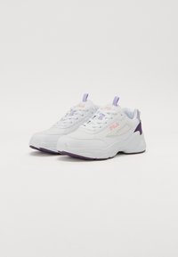White athletic shoes with a textured finish, featuring purple accents and a padded tongue. The design includes a prominent logo on the side.