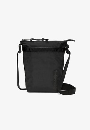 Borsa a spalla nera realizzata in tessuto testurizzato, con chiusura a coulisse, tracolla e logo sul davanti. Forma quadrata con design minimalista.