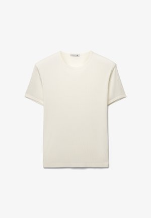 Maglietta a girocollo in bianco sporco, maniche corte, tessuto costellato a coste, vestibilità ampia. Etichetta all'interno del collo con taglia XL.