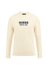Sweter w kolorze kremowym z splotem w warkocze, z granatowym haftem "GUESS SINCE 1981" z przodu oraz ściągaczami przy mankietach i u dołu.