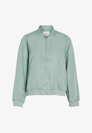 Šviesiai žalia bombonešio striukė, pagaminta iš glotnios, blizgios medžiagos. Turi užtrauktuko užsegimą, šonines kišenes bei ribuotas rankogalius ir apačią.