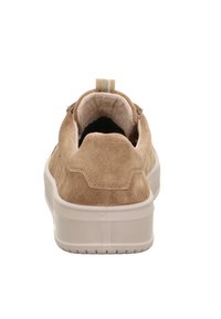 Zamszowy sneaker w kolorze beżowym z białą gumową podeszwą. Posiada wyściełany kołnierz oraz pętlę na pięcie ułatwiającą zakładanie. Gładka faktura.