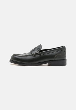 Black leather loafer with a rounded toe, decorative stitching, and a textured accent panel. Low stacked heel, sleek design, and smooth finish.