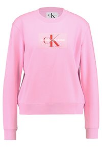 Felpa rosa in misto cotone, con polsini e orlo a costine, vestibilità oversize e toppa rettangolare con logo "CALVIN KLEIN JEANS".