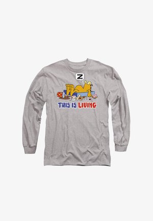 Long-sleeve gray t-shirt featuring a cartoon cat with its feet up, surrounded by food, and the text "THIS IS LIVING" in blue and red.