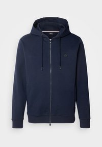 Sweat à capuche zippé bleu marine avec cordons, poignets côtelés et petit logo rond sur la poitrine gauche.