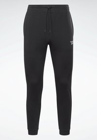 Black sweatpants made of soft fabric, featuring an elastic waistband with drawstring, tapered legs, and ribbed cuffs. Logo detail on the side.