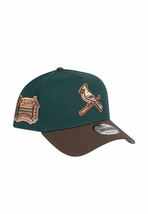 Green and brown baseball cap with embroidered cardinal logo and "Busch Stadium" patch. Features a structured front and curved brim.