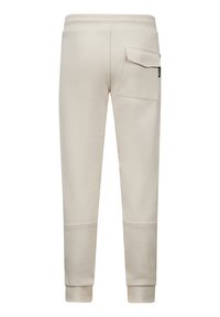 Beige joggingbroek met een getailleerd design, elastische tailleband en een zijvak. Zachte stoffen textuur met ribbels aan de enkels.