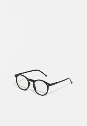 Óculos de sol redondos pretos com lentes transparentes, hastes finas pretas e pequenos detalhes metálicos na parte da frente. Design clássico com estilo minimalista.