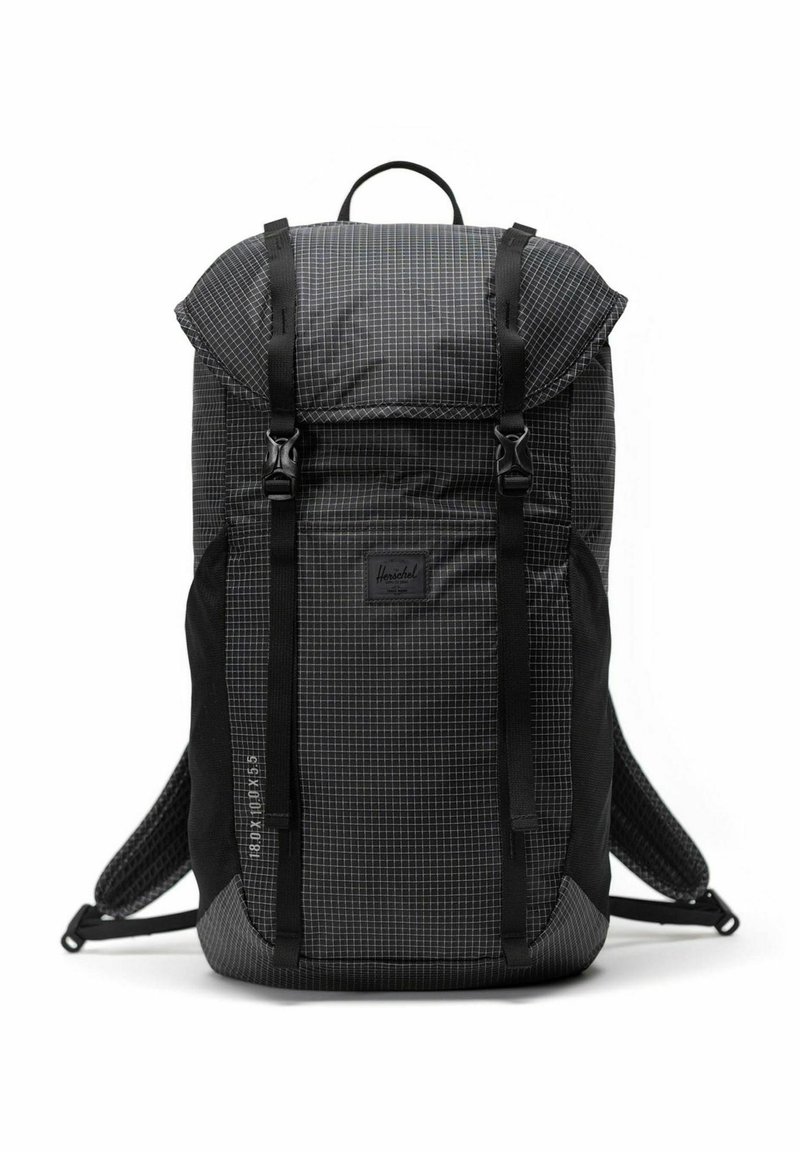 Sac à dos noir à carreaux avec fermeture enroulable, bandoulières ajustables et panneau inférieur renforcé. Présente le logo Herschel à l'avant.