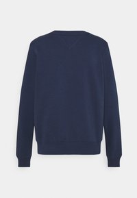 Sweat-shirt bleu marine à manches longues avec col rond, poignets et ourlet côtelés, présenté de dos sur un fond gris clair.