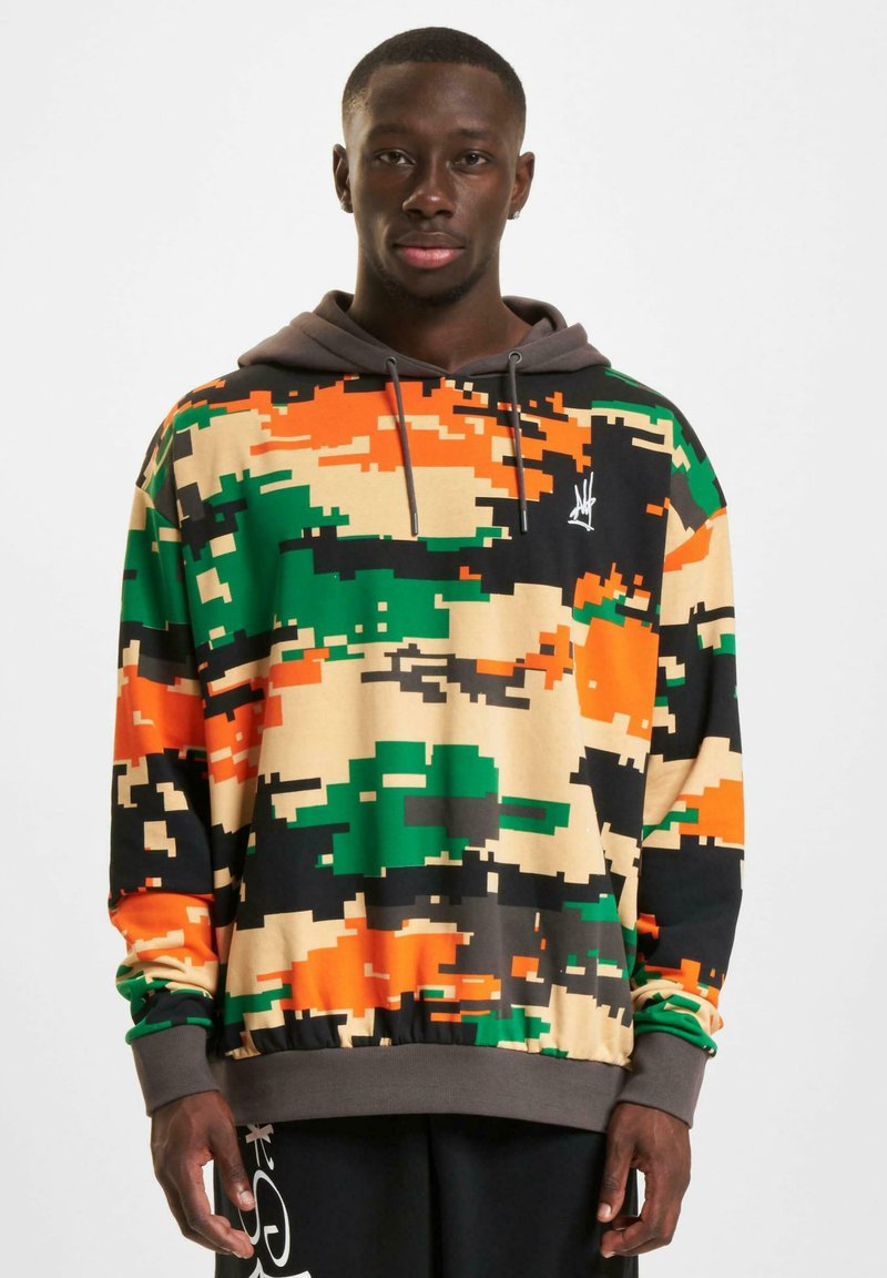 Hooded sweatshirt featuring a pixelated camouflage pattern with green, orange, black, and beige colors; elastic cuffs and hem.