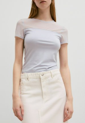 Lichtblauw T-shirt met doorschijnende mesh mouwen, ronde halslijn, aangesloten lijfje, gecombineerd met een witte rok met een klassieke denimmotief.