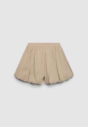 Beige bubble shorts with a gathered design and smooth texture. Elastic waistband. Short length with ample volume and flowy silhouette.