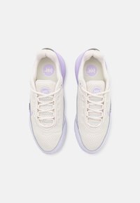 Lightweight mesh sneakers in cream with lavender accents, featuring a rounded toe, lace-up front, and cushioned sole for comfort.