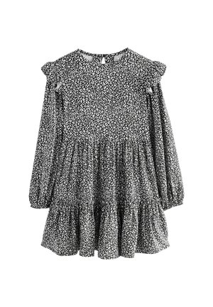 Schwarz-weißes Langarmkleid mit Rüschenschultern, schichtenweise Rock und floralem Muster, mit einem Schlüssellochverschluss auf der Rückseite.