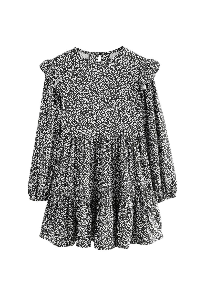 Schwarz-weißes Langarmkleid mit Rüschenschultern, schichtenweise Rock und floralem Muster, mit einem Schlüssellochverschluss auf der Rückseite.