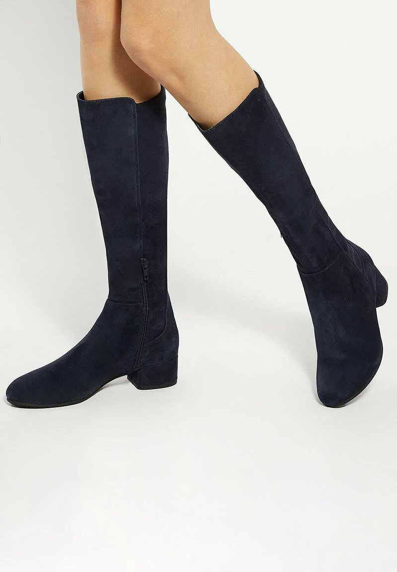 Navy suede knee-high boots with a slightly rounded toe and a block heel, featuring a side zipper and smooth texture.