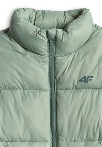Doudoune vert clair avec col montant, fermeture éclair visible au centre et logo 4F sur le côté gauche de la poitrine.