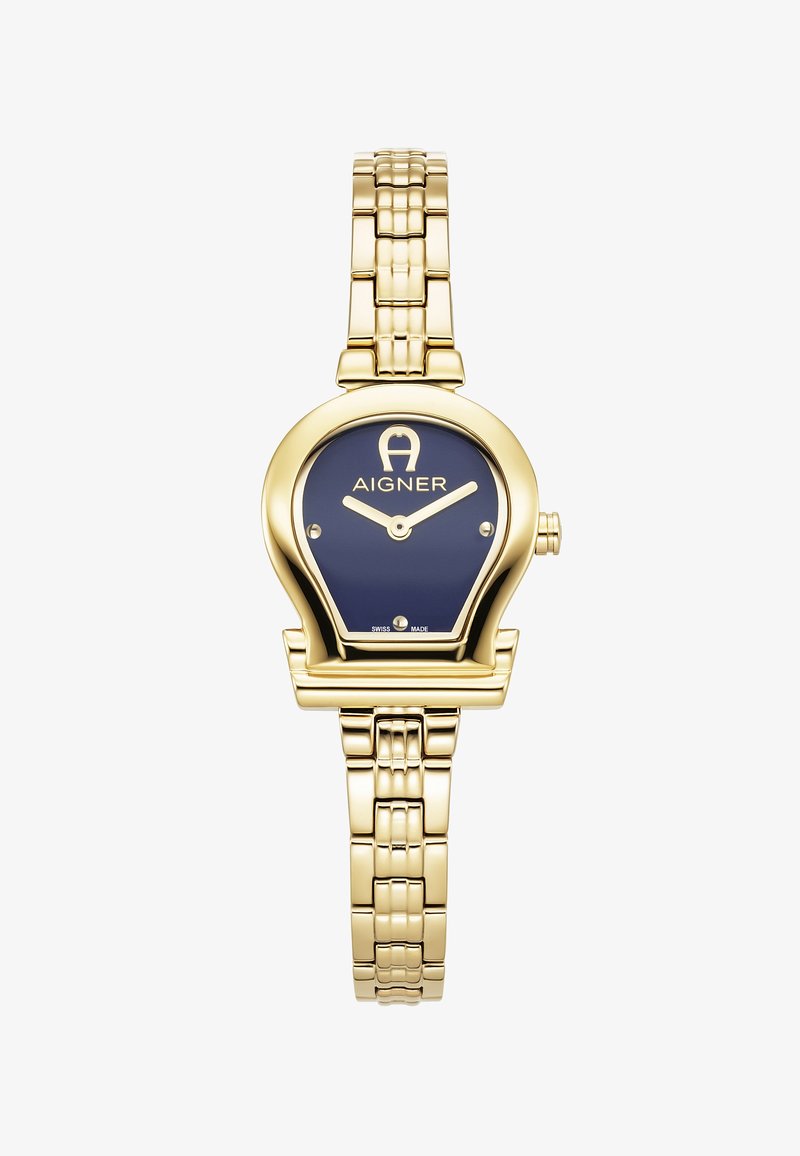 Guldtonad klocka med blå urtavla, som har ett ovalt hölje, silverfärgade visare och ett länkarmbandsdesign. Tillverkad i Schweiz.