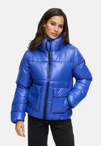 Blue puffer jacket made of shiny material, featuring a high collar, front zipper, and two front pockets. Designed with quilted sections.