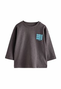 Sweatshirt gris en tissu mélangé coton. Dispose d'un col rond et de manches trois-quarts. L'avant présente un texte graphique bleu "SMILE".