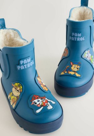 Blue rubber rain boots with plush lining, featuring colorful Paw Patrol character stickers on the sides and a textured sole for grip.