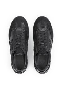 Pair of black leather and suede sneakers with laces, visible stitching, and branded insoles placed side by side on a white background.