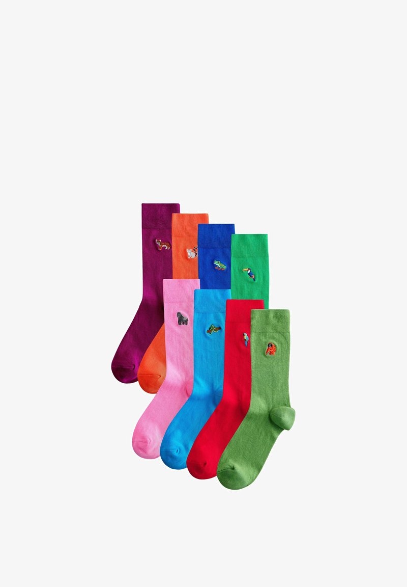 Sept chaussettes colorées avec des motifs brodés d’animaux comprenant un renard, un tigre, une grenouille, un toucan, un gorille, un papillon et un perroquet.