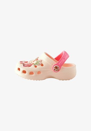 Light pink clogs with a textured finish, featuring colorful plastic embellishments and perforations for ventilation. Adjustable back strap.