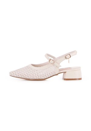 Zapato slingback beige de tacón bajo, con puntera puntiaguda, empeine de malla tejida y dos correas ajustables con hebilla.