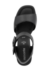Black leather sandal featuring a wide upper strap and adjustable ankle buckle, with a cushioned insole and rounded toe design.