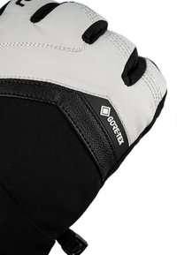 Close-up of a black and white winter glove with Gore-Tex label and reinforced stitching on the top side.
