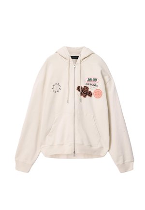 Crèmekleurige hoodie met rits, voorzakken, trekkoord aan de capuchon en meerdere geborduurde patches, waaronder "ALLSAINTS" en palmbomen op de borst.