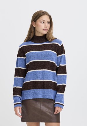 Blue, brown, and white striped sweater with a high neckline and long sleeves; made from a soft, textured fabric. Paired with a brown leather skirt.