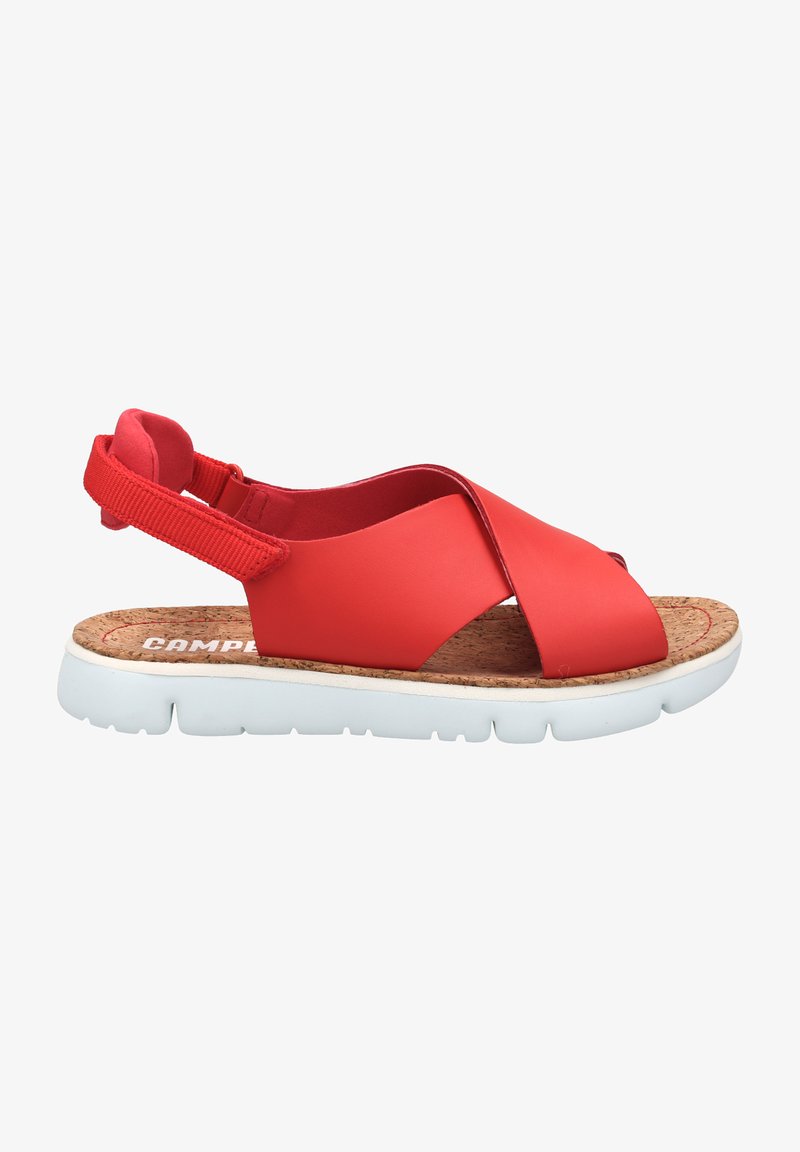 Punaiset synteettiset sandaalit ristikkäisillä remmeillä, korkkipohjalla ja valkoisella pehmustetulla pohjalla. Säädettävä kantapäänremmi turvallista istuvuutta varten.
