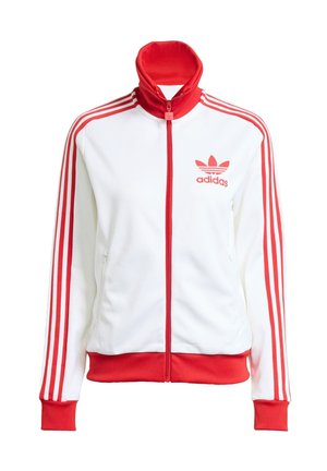 White track jacket with red accents, full zip, high collar, three red stripes on sleeves, and embroidered red Adidas logo on the chest.