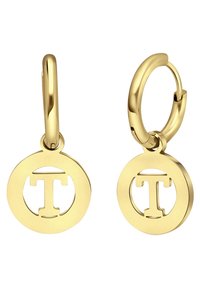 Gouden hoepeloorbellen met een ronde hanger waarin een uitgesneden letter 'T' in het midden is, met een gladde textuur en een gepolijste afwerking.
