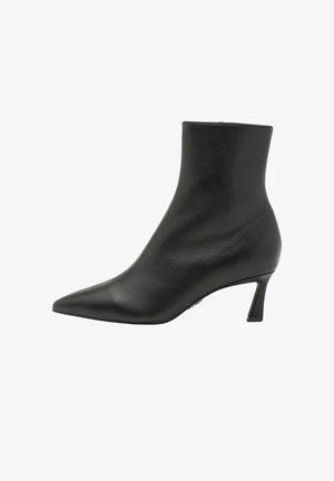 Stivale alla caviglia in pelle nera con punta affusolata e un tacco sottile e angolare. Texture liscia, dettagli minimi e una silhouette elegante.