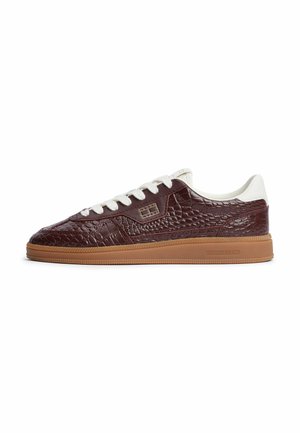 Low-top sneaker with dark brown textured leather upper, white laces and heel tab, and a light brown rubber sole.