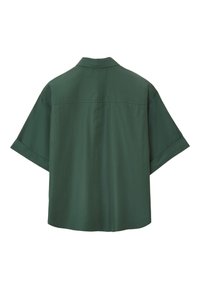 Short-sleeve, dark green shirt with a relaxed fit, collar, and smooth texture; features a central seam down the back.