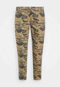 Calças de camuflagem em padrões verde, castanho e preto. Feitas de um tecido com uma textura suave e cintura elástica para maior conforto.